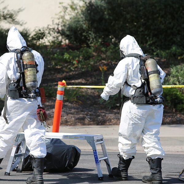 Lake Forest, California, May 23, 2017: Hazardous materials team, cleans up a single truck accident containing swimming pool chemicals, preventing poisonous liquids from release into the environment.